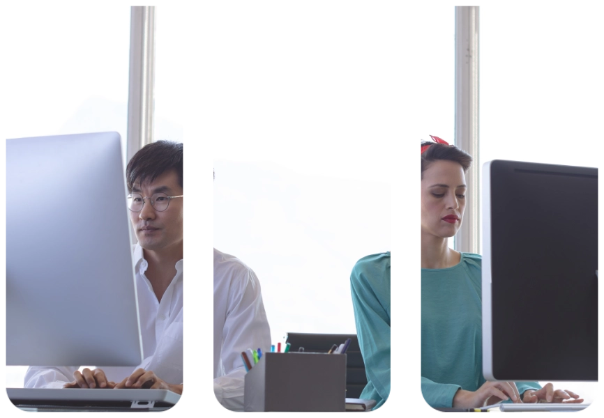 Front view of business people working on computer at desk in modern office