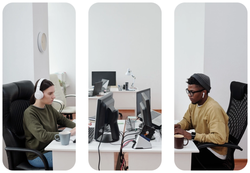 Side view of two young intercultural programmers working in front of computers
